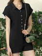 Black romper by Ivy's Gifts & Boutique featuring short sleeves, button front, and wide short legs, shown on a hanger.