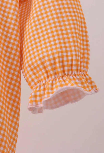 Long sleeve orange and white gingham bubble with embroidery from TN4 Premium by Ivy's Gifts & Boutique, shown on a child.