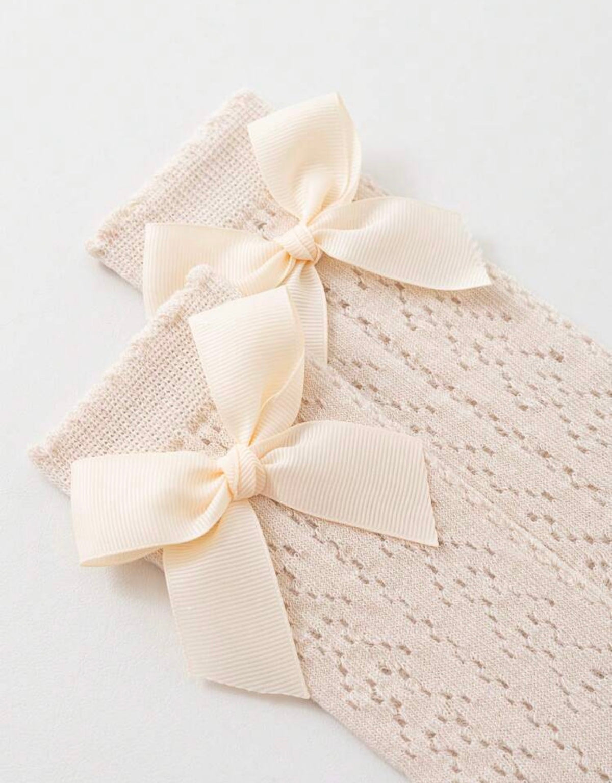 Baby knee socks with bow detail from Ivy's Gifts & Boutique, soft knit fabric, perfect for infants' delicate legs.