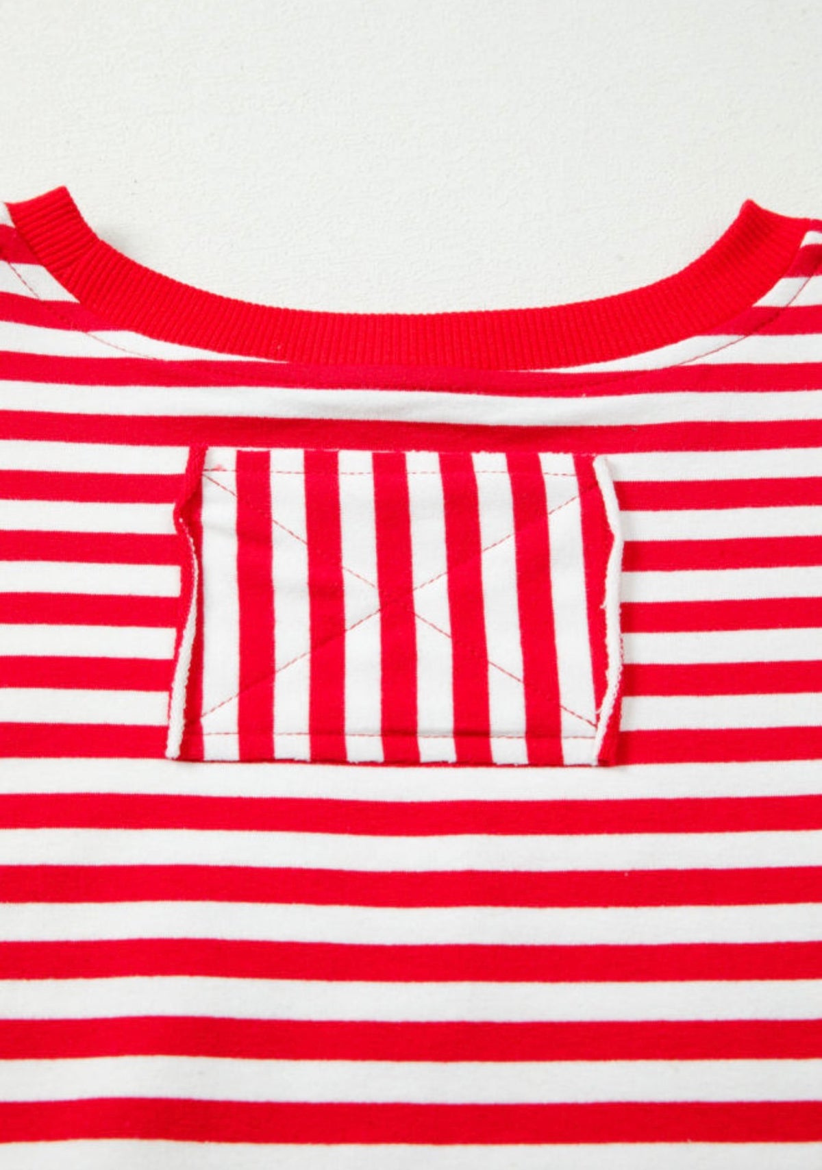 Red and white striped long sleeve top by Ivy's Gifts & Boutique with raw edges and a square patch on the back.