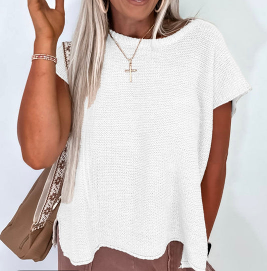 White sleeveless sweater with side splits