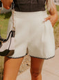 White waffle weave shorts with pockets and elastic waist from Ivy's Gifts & Boutique, shown on a neutral background.