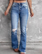 Distressed blue jeans with flare leg and frayed hem from Ivy's Gifts & Boutique, showcasing trendy casual denim style.