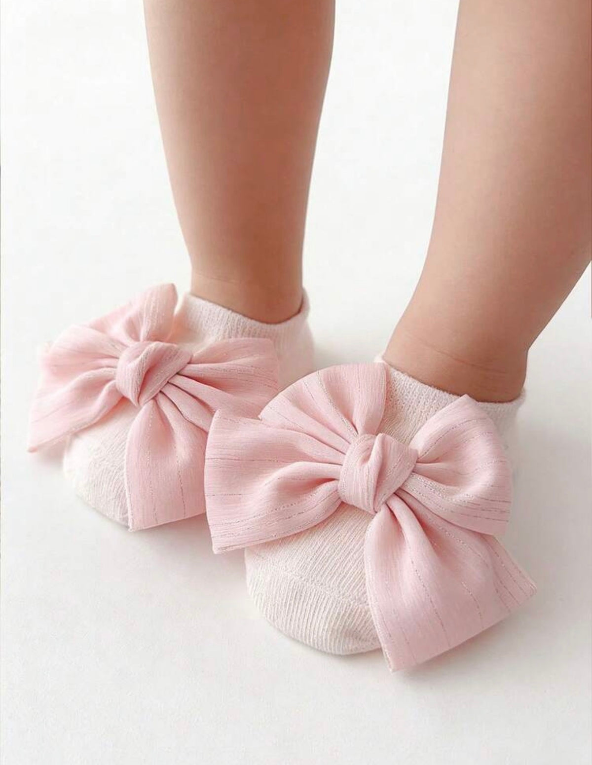 Baby's BT1 infant gripper sock with toe bow embellishment, featuring soft fabric and non-slip grip for safety and style.
