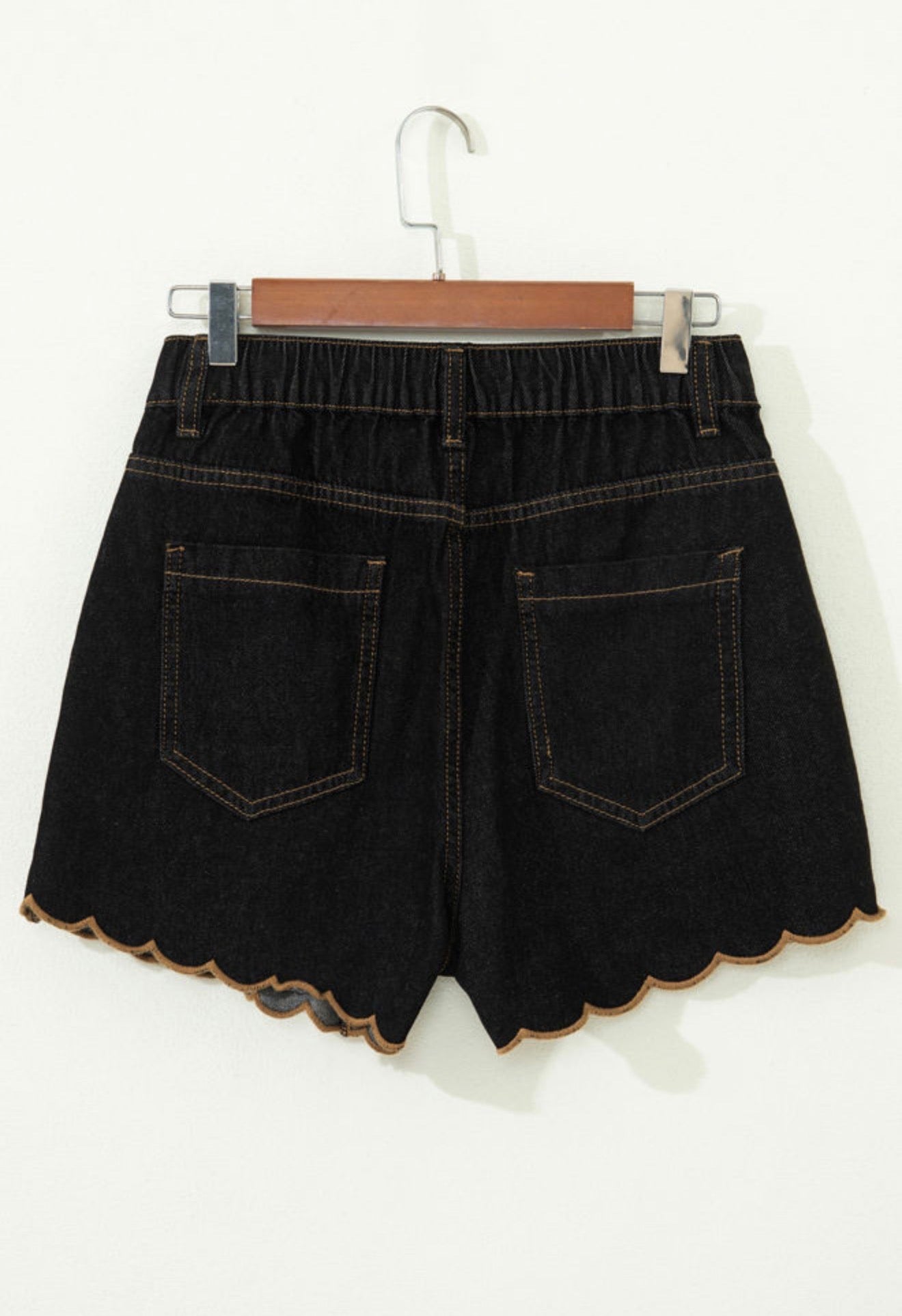 Black stretch denim scallop hem shorts by Ivy's Gifts & Boutique, featuring a stylish scalloped edge and fitted design.