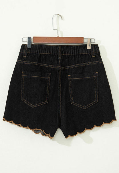 Black stretch denim scallop hem shorts by Ivy's Gifts & Boutique, featuring a stylish scalloped edge and fitted design.