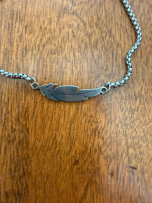 Silver feather design bracelet with slide adjustable latch, featuring elegant Ivy's Gifts & Boutique jewelry style.