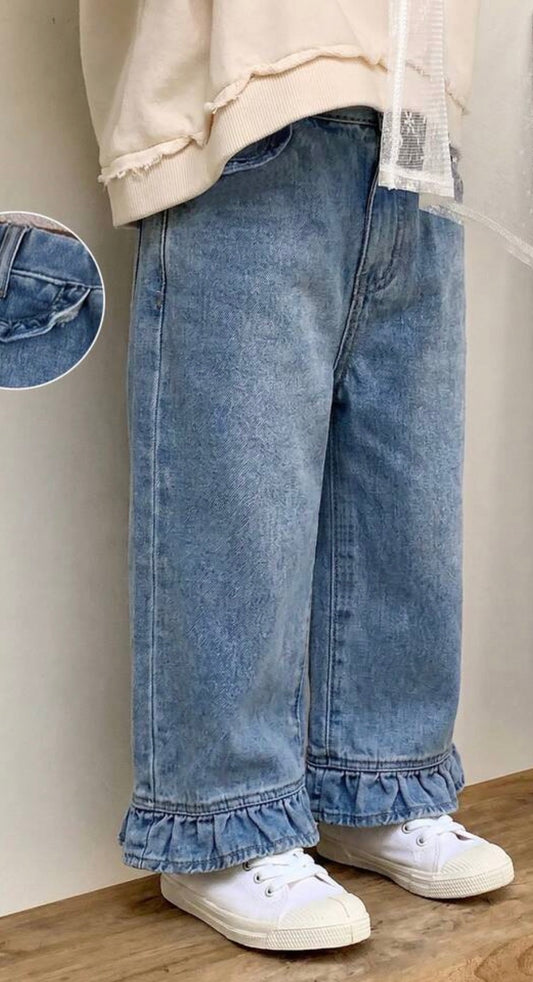 Medium wash denim pants with ruffle hem and pockets from Ivy's Gifts & Boutique, featuring a relaxed fit and stylish detail.