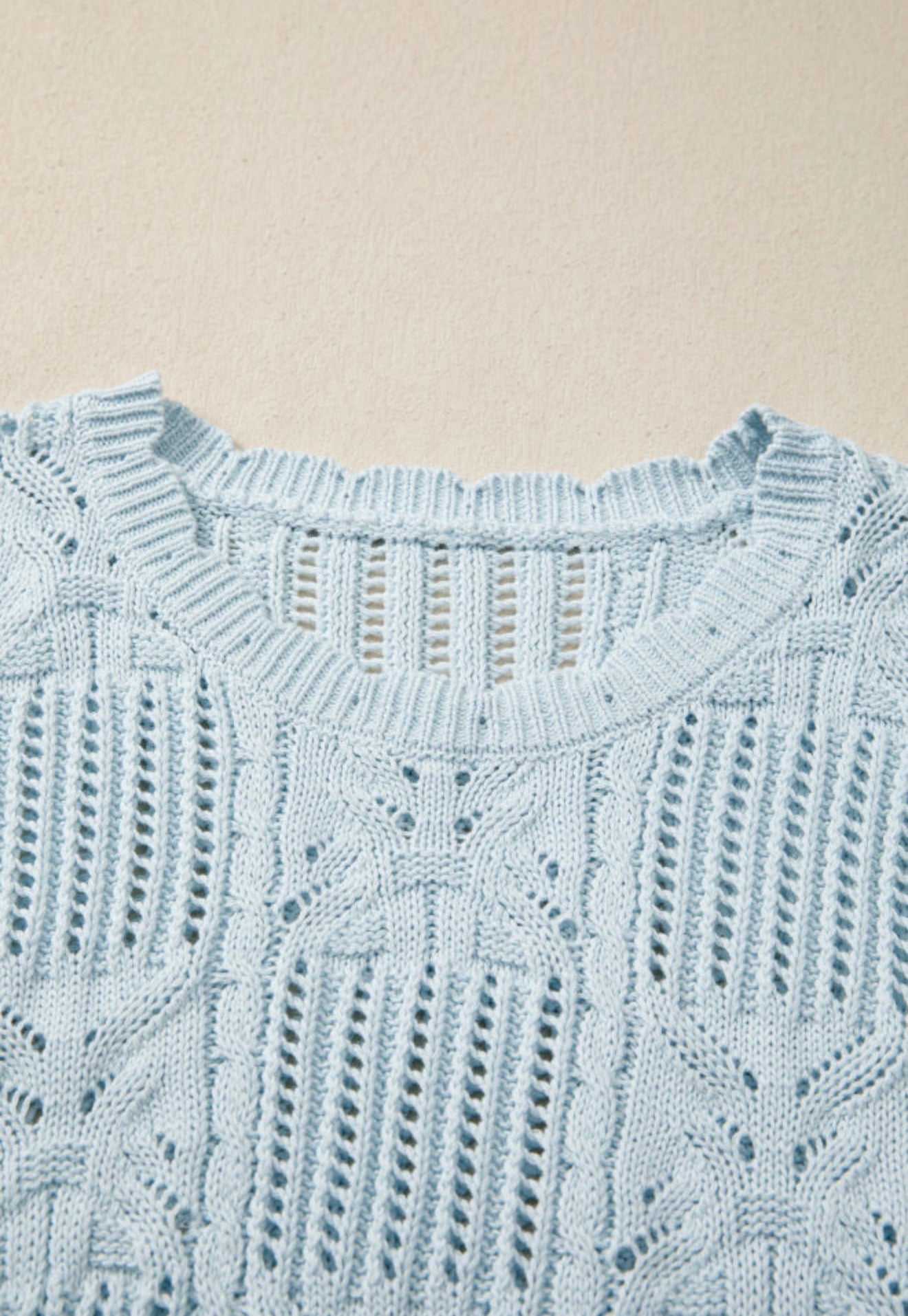 Light blue summer sweater with side tie accents from Ivy's Gifts & Boutique, featuring a relaxed fit and casual style.