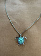Sea turtle pendant necklace featuring a detailed turtle design, crafted by Ivy's Gifts & Boutique.