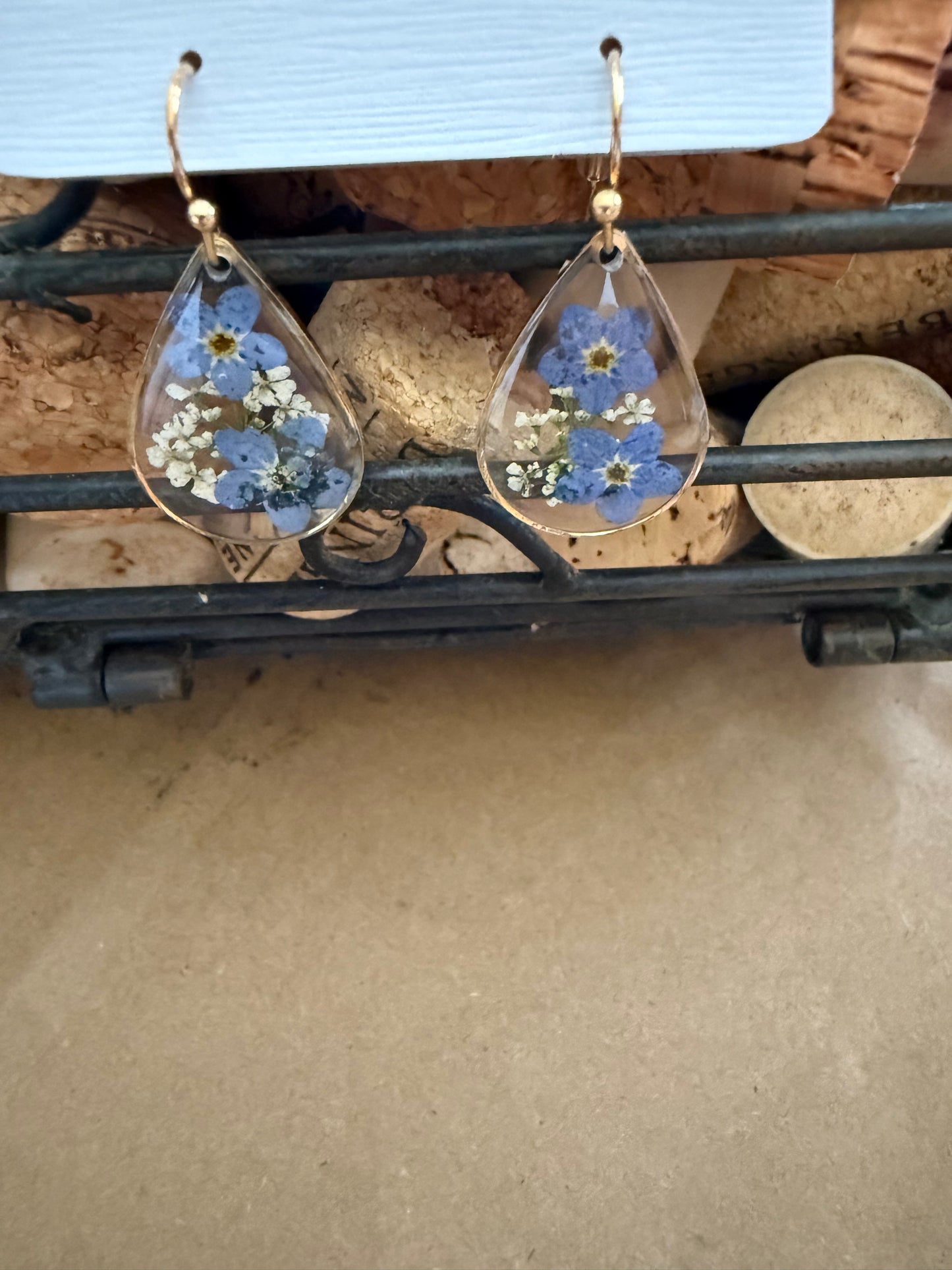 Dried flower earrings by Ivy's Gifts & Boutique featuring delicate, colorful pressed flowers in silver-tone hooks.