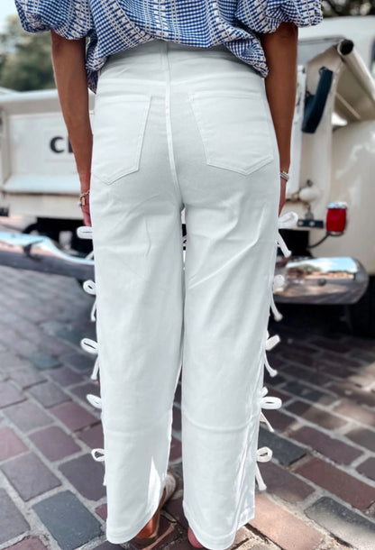 White jeans with side seam bow details from Ivy's Gifts & Boutique, showcasing the stylish design and fit.