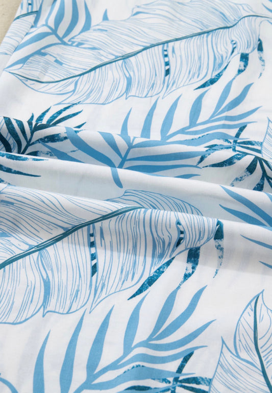 Wide leg blue tropical leaf print pants with pockets and elastic waist from Ivy's Gifts & Boutique.