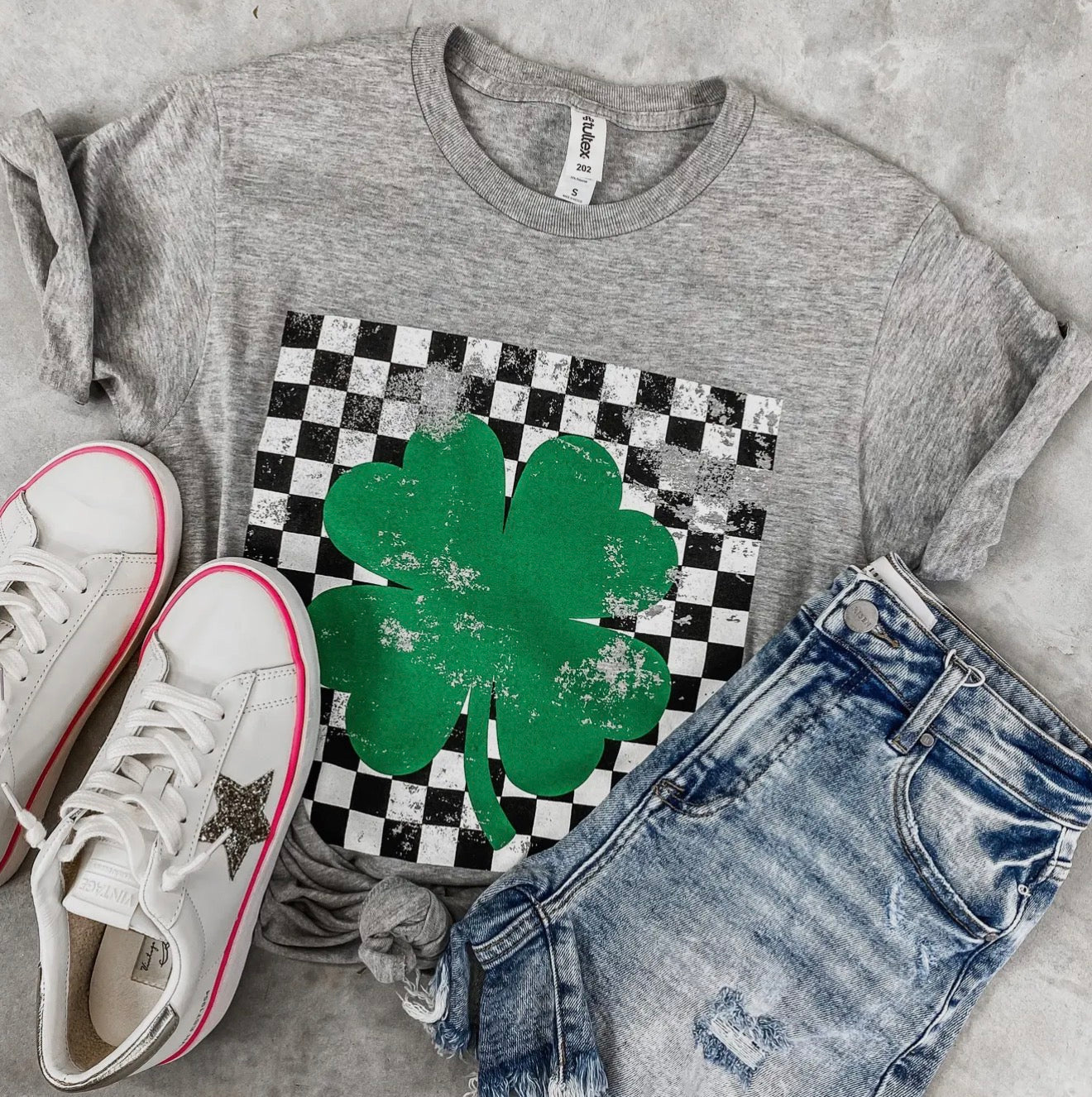 Green checkered shamrock T-shirt from Ivy's Gifts & Boutique, featuring a festive design perfect for St. Patrick's Day.
