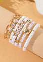 Stackable bracelet set of 7 from Ivy's Gifts & Boutique, featuring colorful beaded and metal designs for stylish wear.