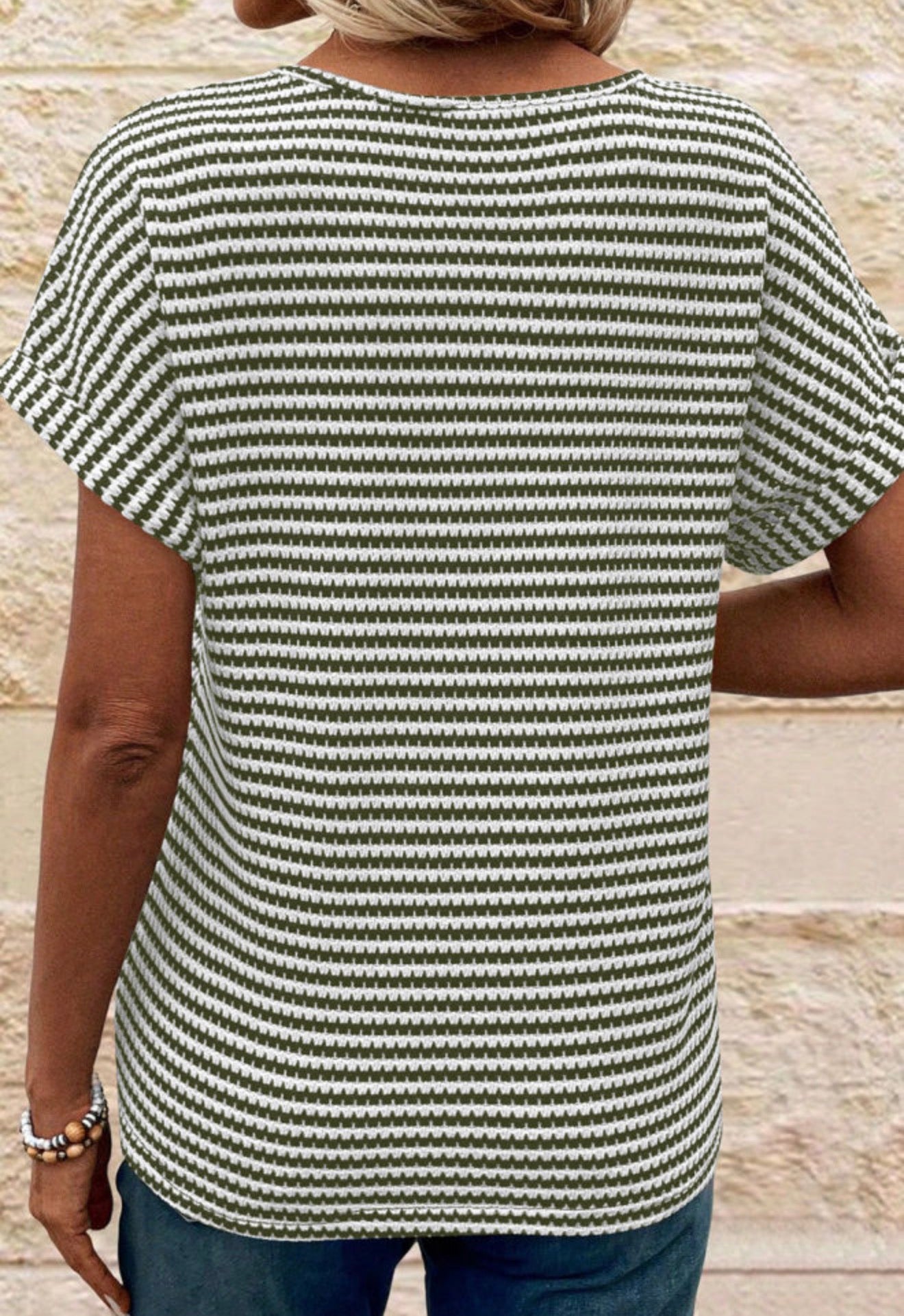 Green and white striped textured notched V-neck short sleeve top from Ivy's Gifts & Boutique, showcasing its stylish design and fabric details.