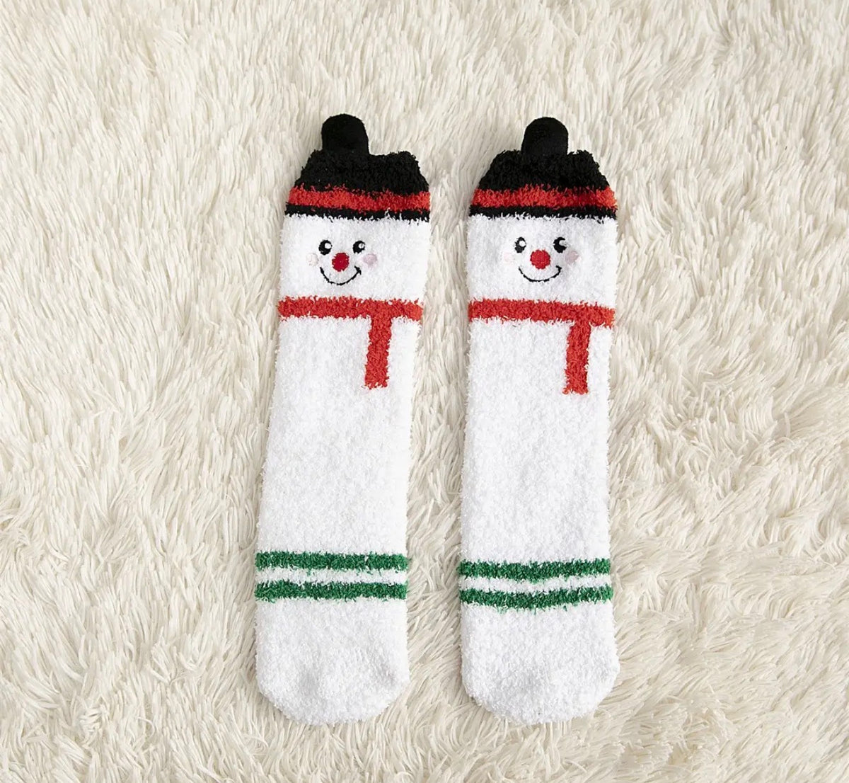 Ivy's Gifts & Boutique holiday socks with pom pom accents, featuring festive patterns and cozy knit fabric.