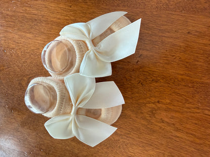 Ivory baby booties with small bow from Ivy's Gifts & Boutique, designed for infants, soft and adorable for little feet.