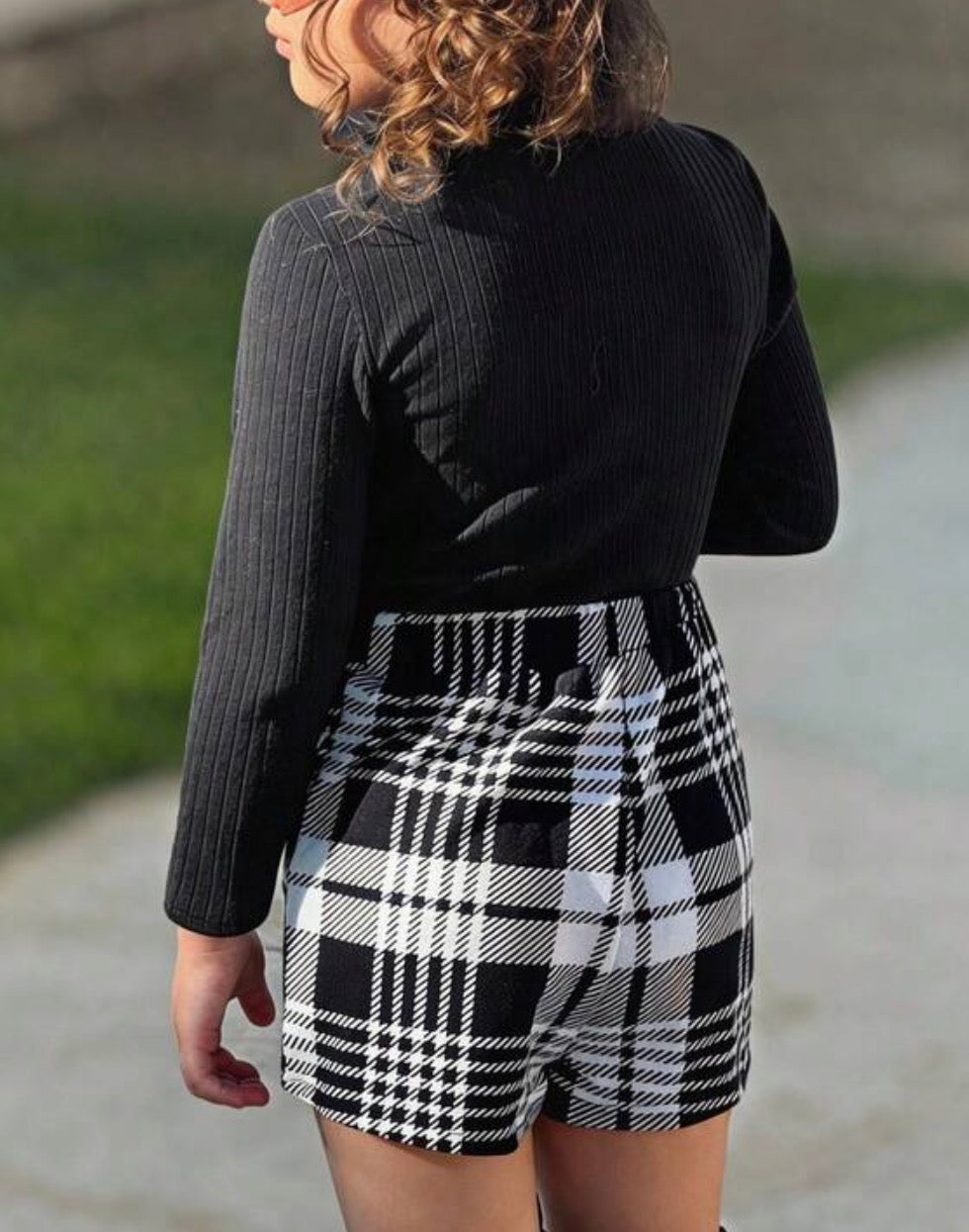 Black and white plaid skort set with high-neck black long sleeve top by Ivy's Gifts & Boutique, shown on a model.
