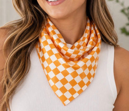 Orange and white checkered Gameday scarf by Ivy's Gifts & Boutique, featuring a stylish checkered pattern.