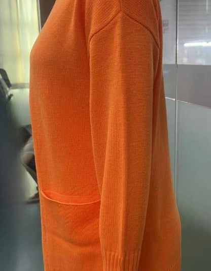 Orange casual knit open front cardigan with pockets by Ivy's Gifts & Boutique, displayed on a hanger.