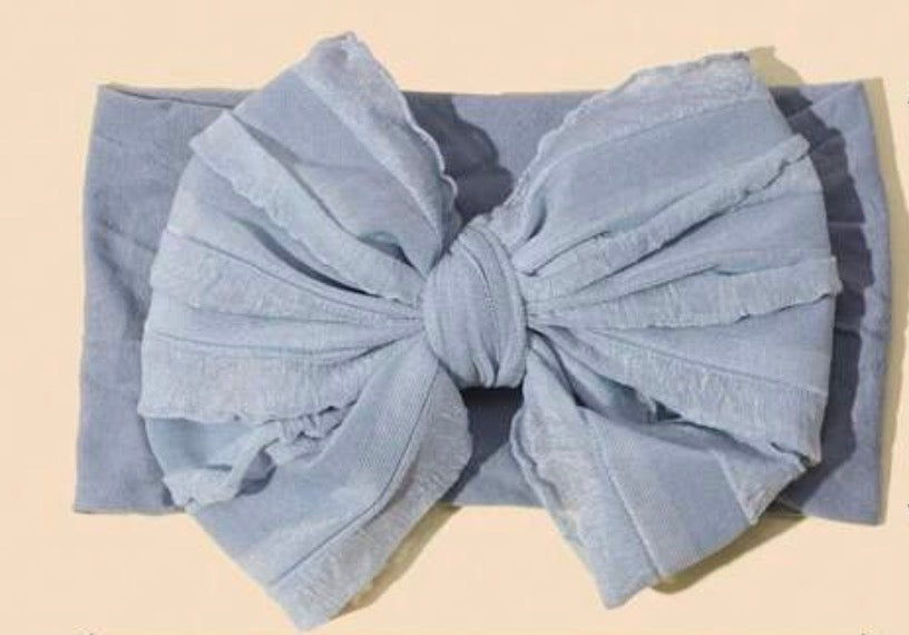 Soft infant headband with bow from Ivy's Gifts & Boutique, featuring a comfortable, stretchy design for baby girls.
