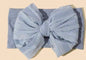 Soft infant headband with bow from Ivy's Gifts & Boutique, featuring a comfortable, stretchy design for baby girls.