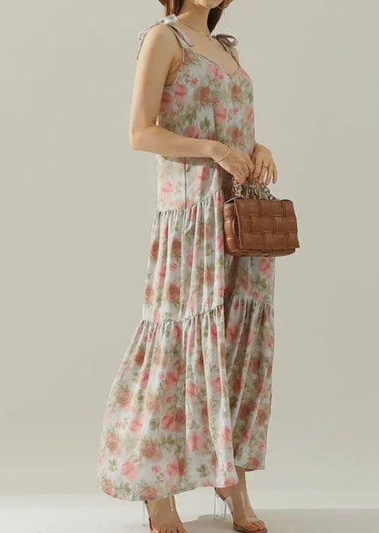 Floral maxi dress with shoulder strap tie detail from Ivy's Gifts & Boutique, featuring a flowy silhouette and vibrant floral pattern.