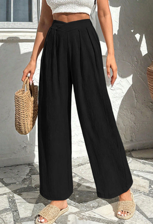 Black relaxed fit wide-leg pants with pockets, made by Ivy's Gifts & Boutique, shown on a model with a casual stance.