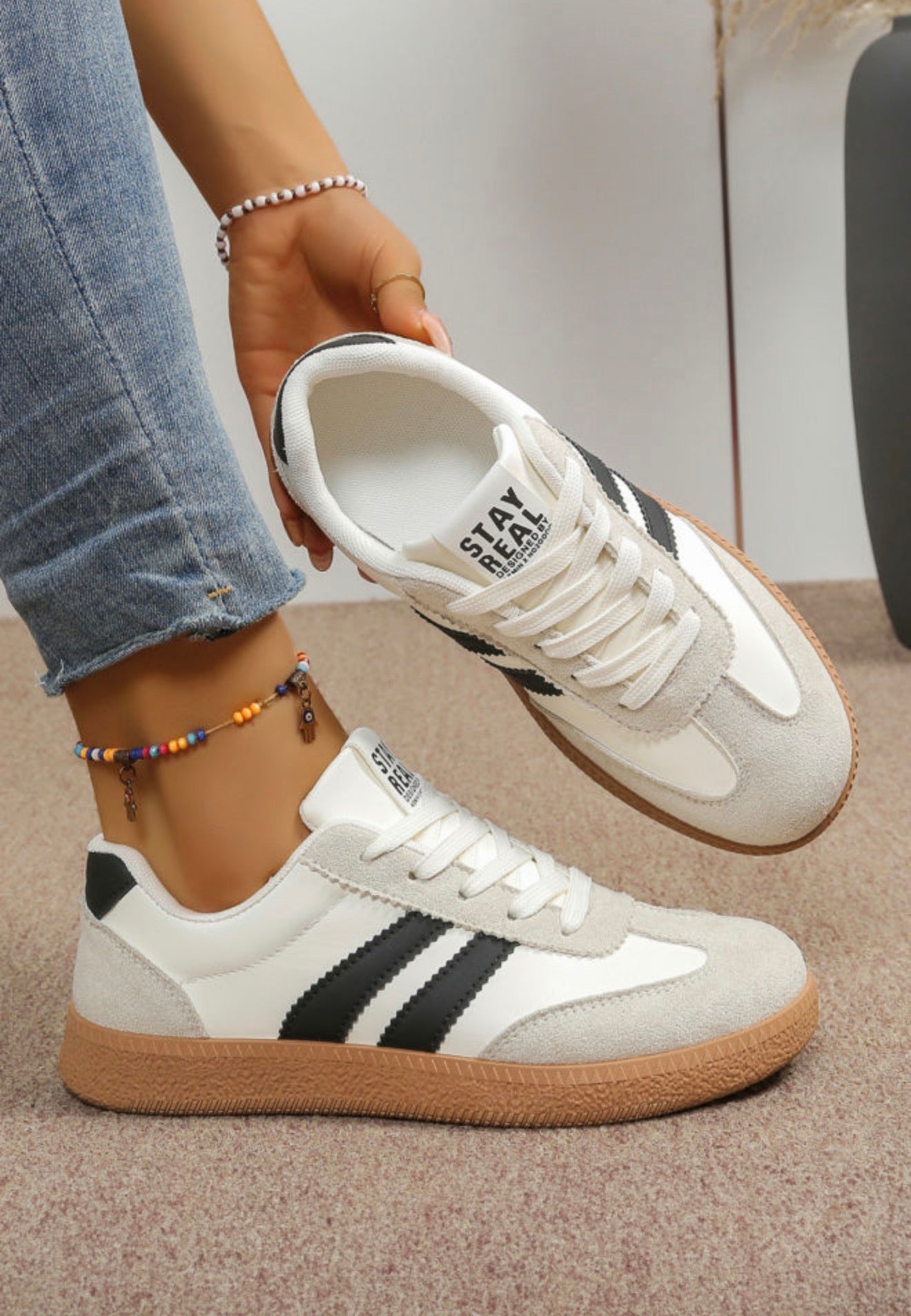 Black and white Ivy's Gifts & Boutique sneakers with sporty stripe design, featuring stylish laces and a comfortable athletic sole.
