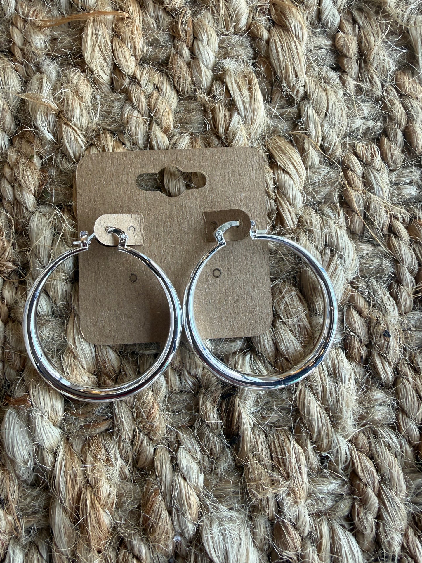 Silver hoop earrings, 1.5 inches in diameter, featuring classic Ivy's Gifts & Boutique jewelry design.