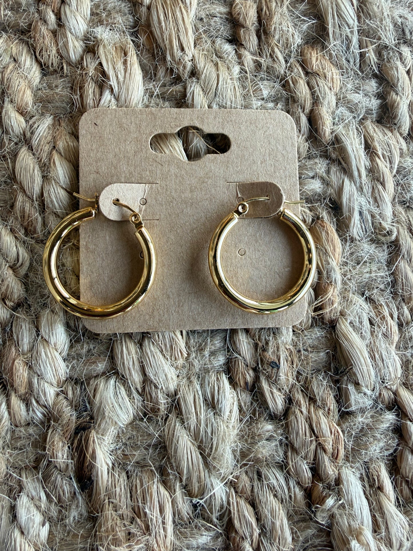 Gold hoop earrings, 1 inch, J15 style by Ivy's Gifts & Boutique, featuring shiny circular hoops on a plain background.