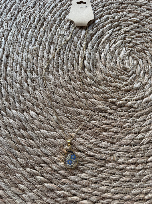 Blue dried flower necklace by Ivy's Gifts, featuring delicate blooms in a stylish pendant design.