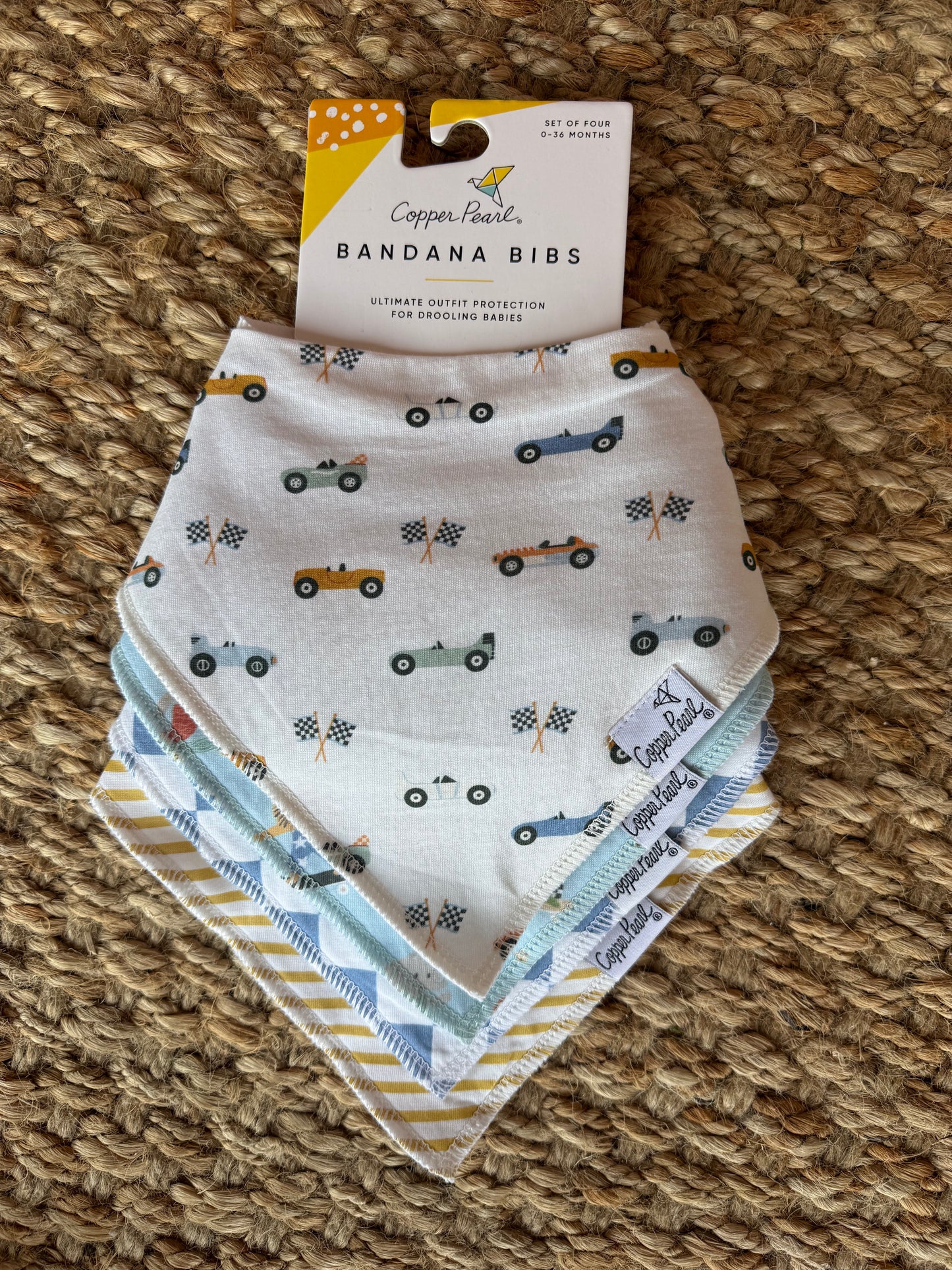 Copper Pearl bandana bibs featuring stylish, absorbent fabric for babies, with a trendy pattern and adjustable snaps.